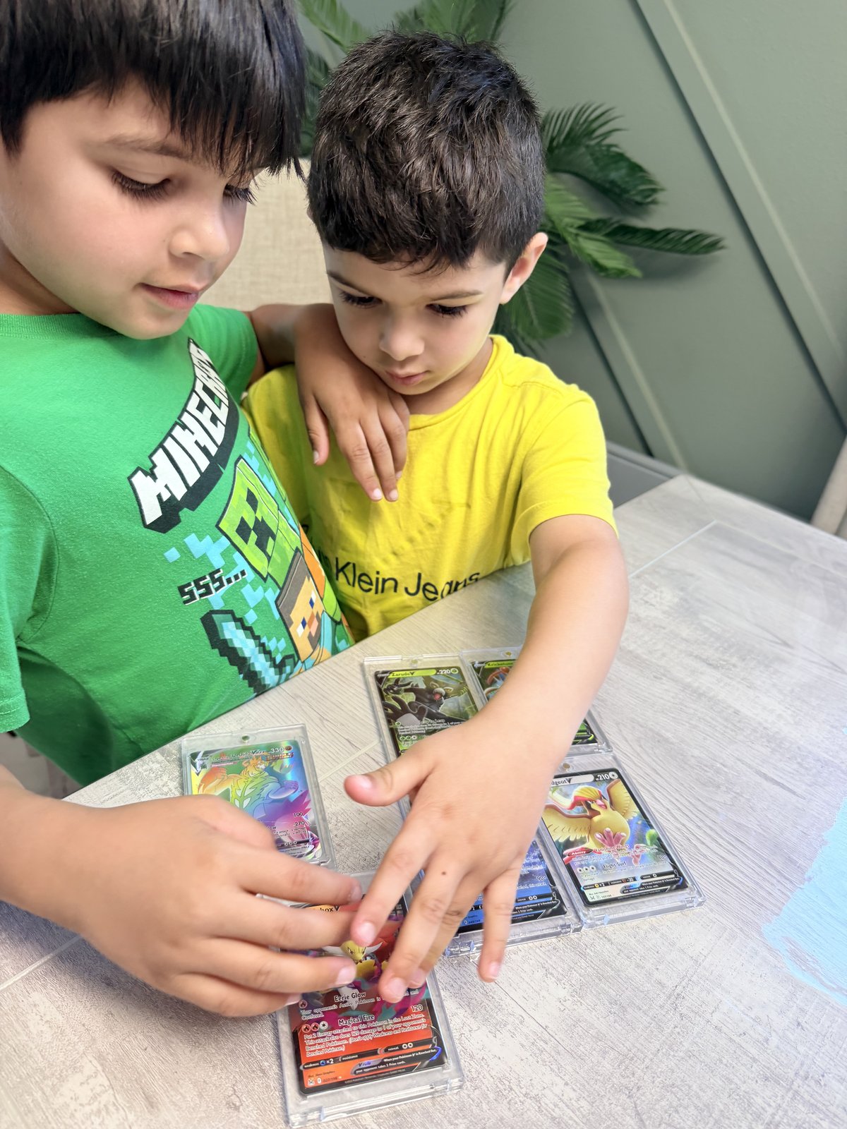 Two kids ripping cards together at the Sports Repack table
