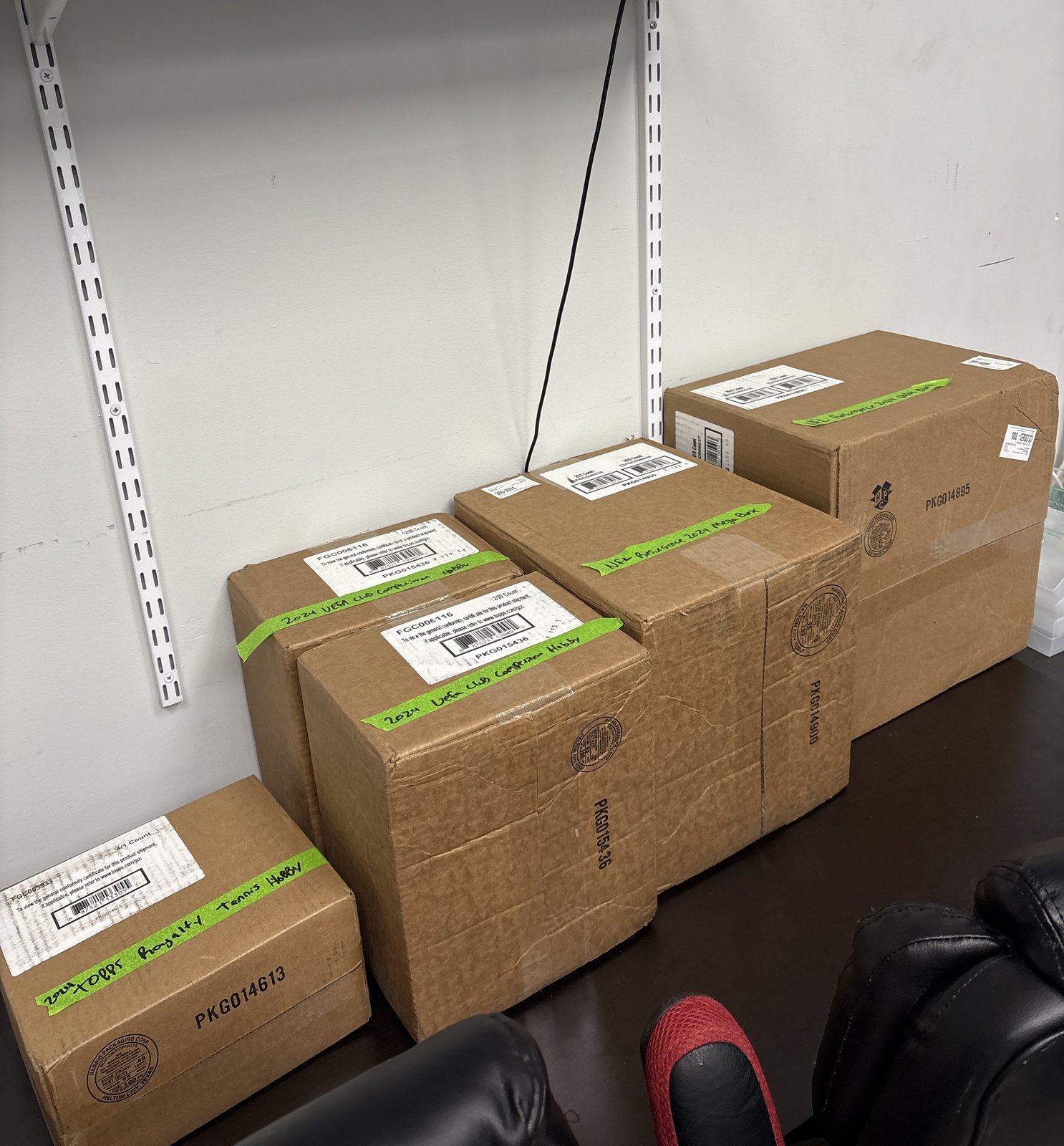 Four packages with green Sports Repack tape ready to ship