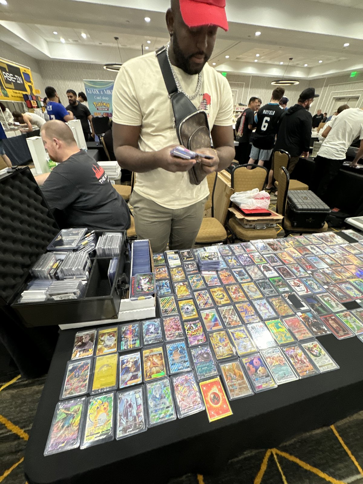 Sam at a trade show with the full Sports Repack table laid out