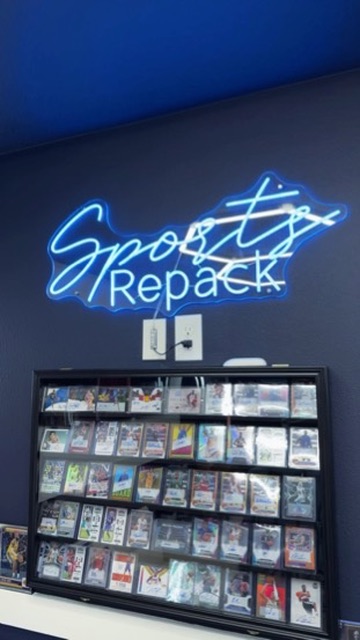 Sports Repack studio · Tampa Bay · neon sign and card display wall